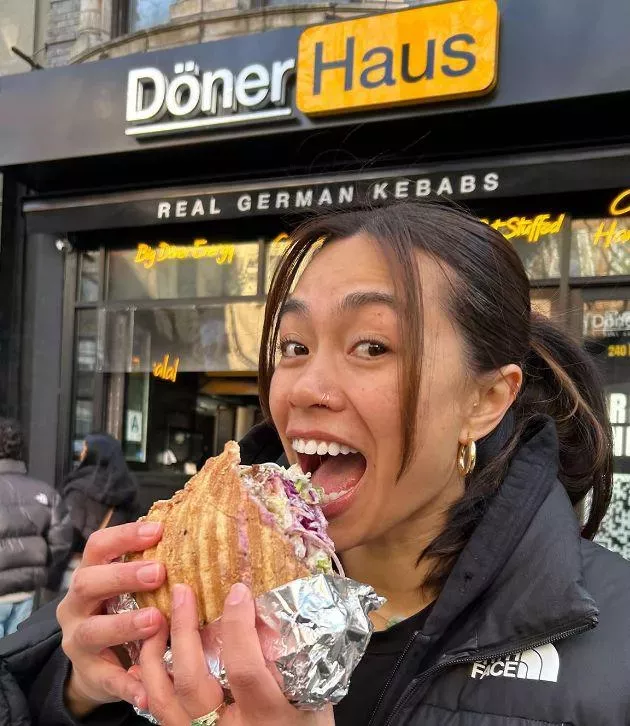 Eating a pide döner on the sidewalk in front of the shop