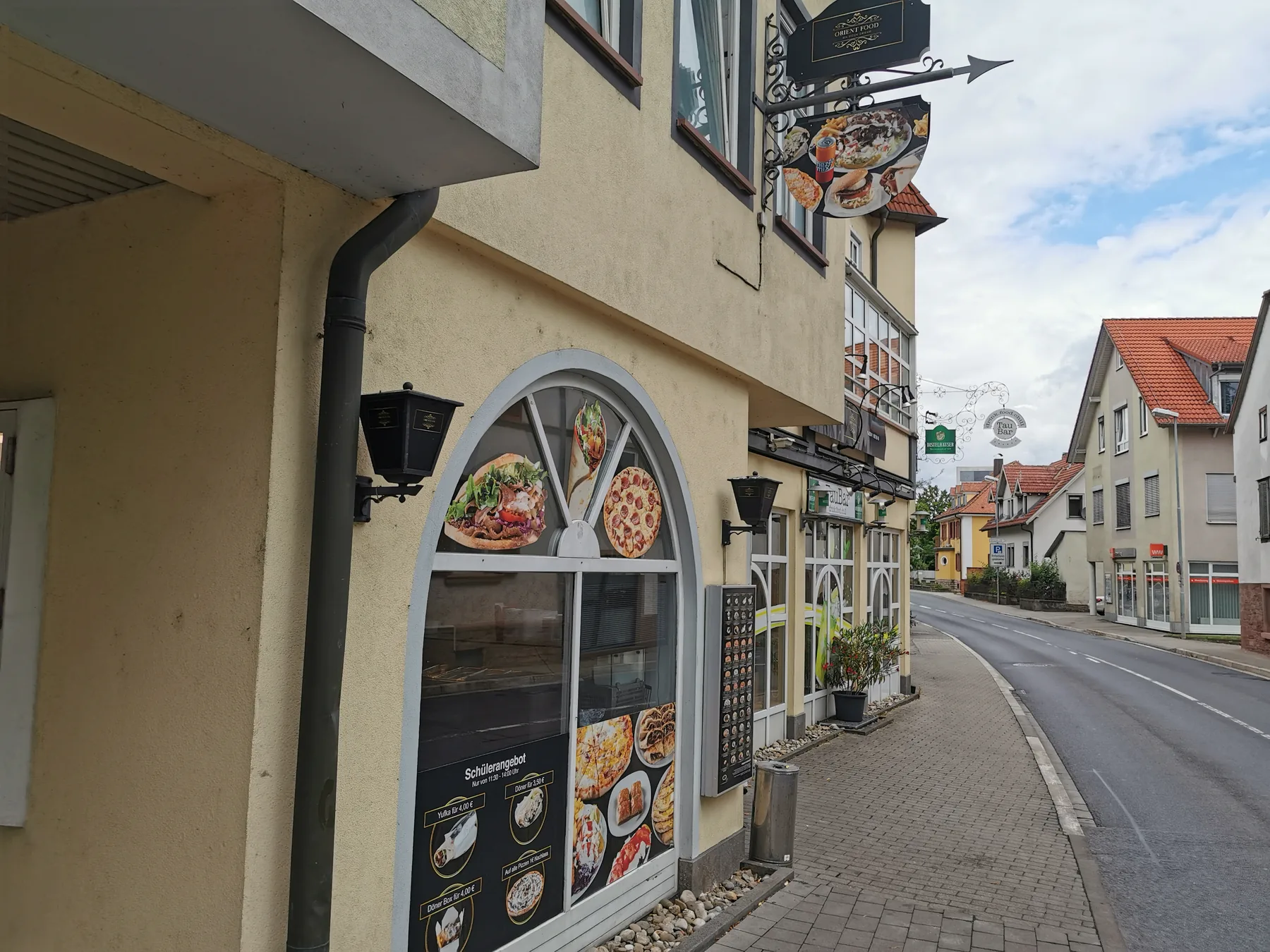 A neighborhood döner restaurant facade with menu photographs in Tauberbischofsheim, Germany