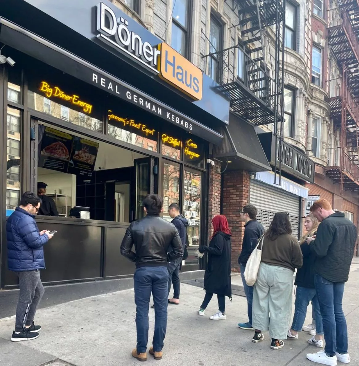 A Döner Haus storefront with its serving window onto the street